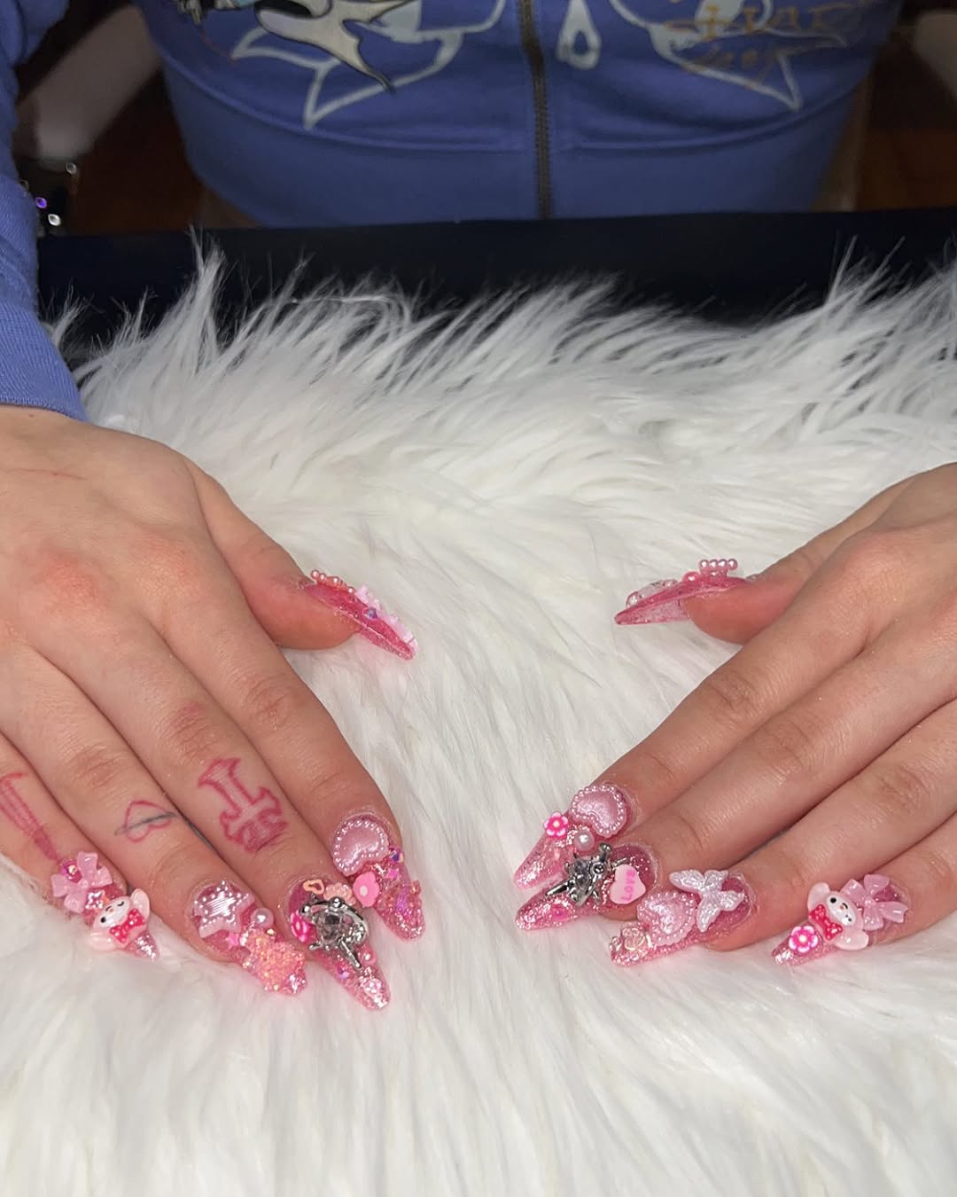 Pink glitter stiletto nail set with 3D bows and pearl charms