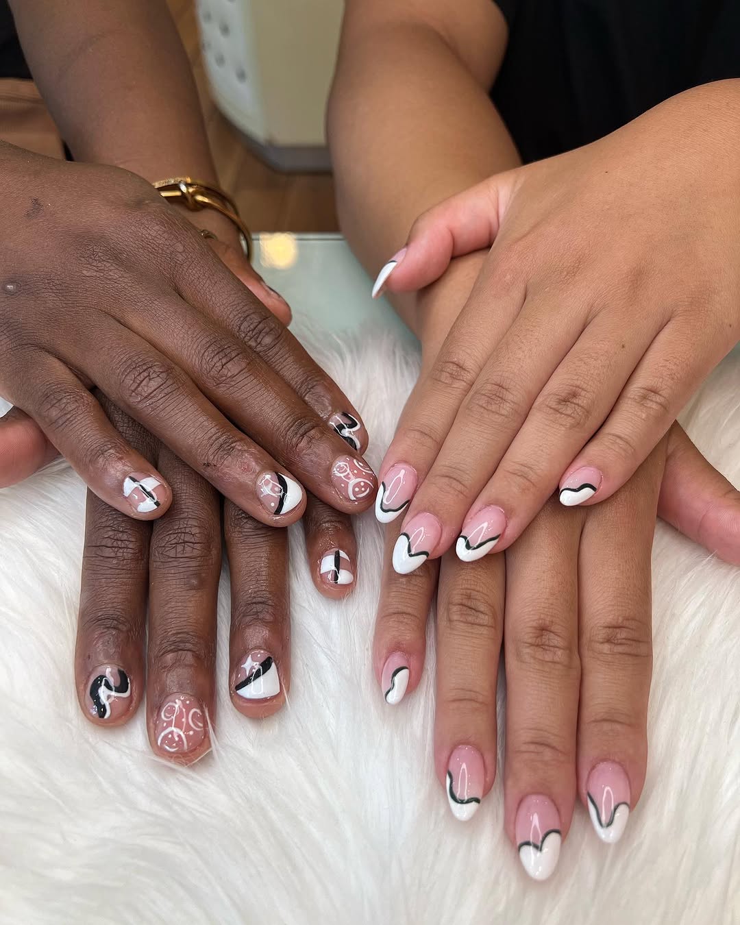 Nail art on two guests' hands, black-and-white heart design, Tina's Nails Seattle